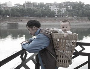father carrying son in basket